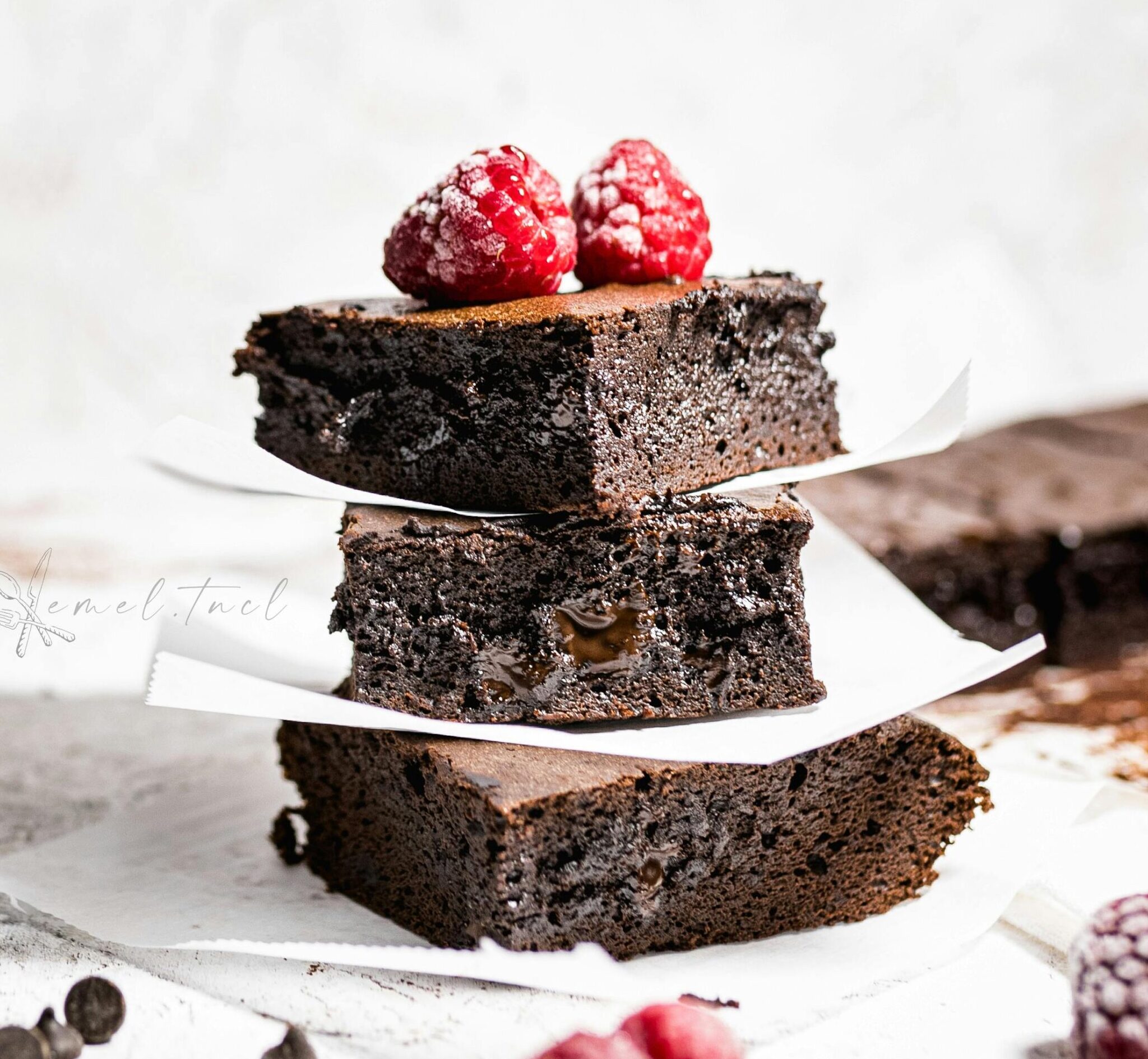 Delicious chocolate brownies topped with raspberries, perfect for dessert lovers.