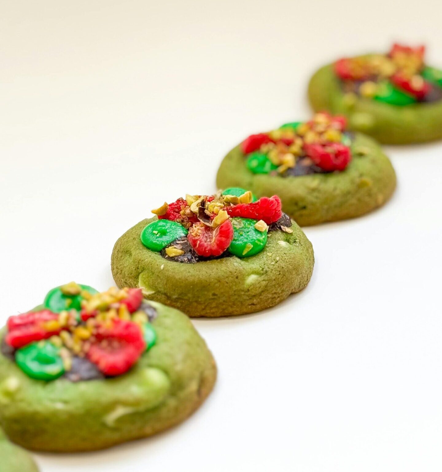 Delicious matcha cookies topped with colorful dried fruits and nuts, perfect for dessert enthusiasts.